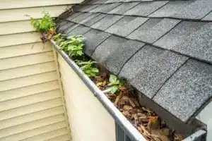 clogged downspout overflowing with water from gutter